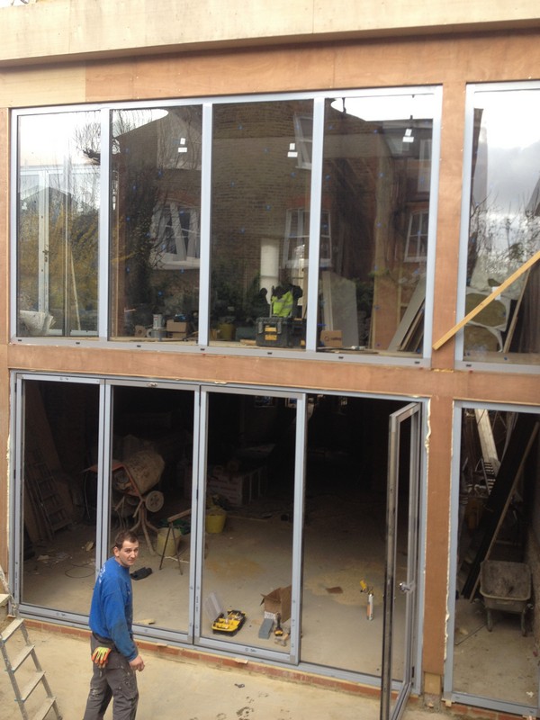 Aluminium bi-fold doors with two-storey glazing in Feltham