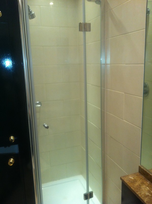 Frameless glass shower enclosure with chrome fittings in Feltham