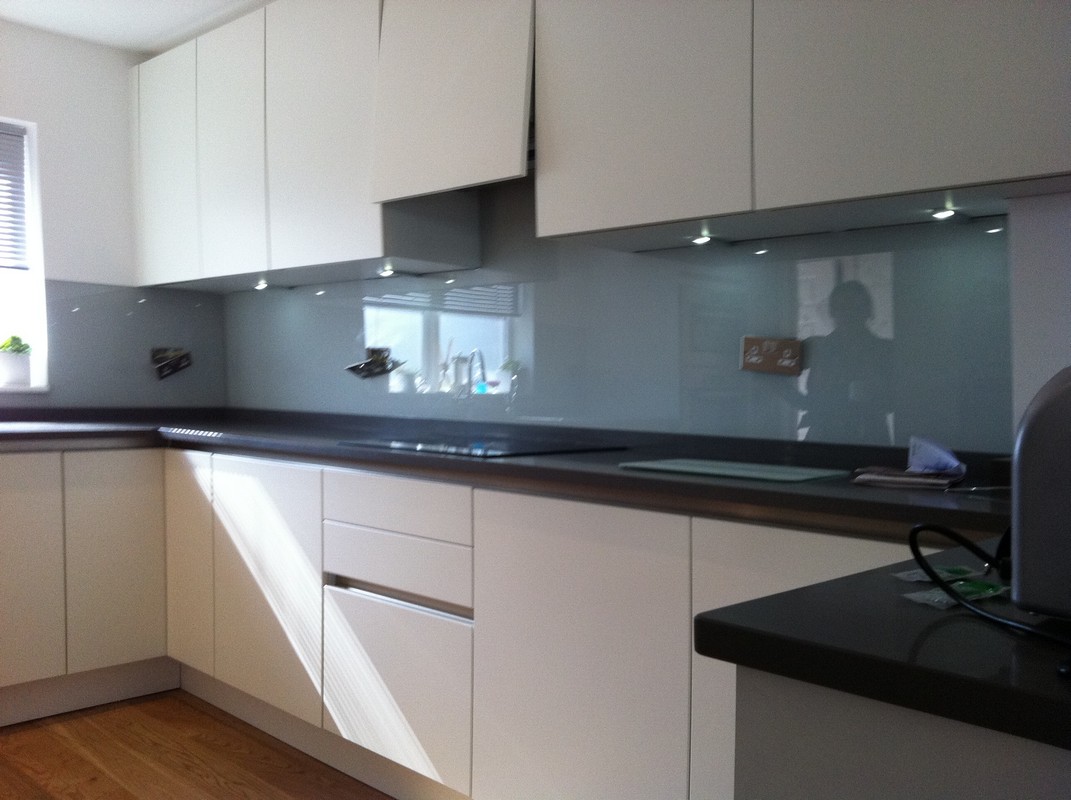 Grey glass kitchen splashback with LED lighting in Feltham