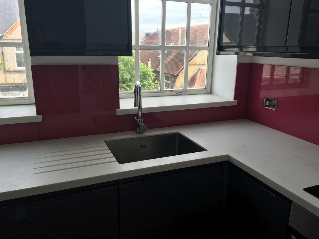 Deep plum coloured glass splashback in modern Feltham kitchen